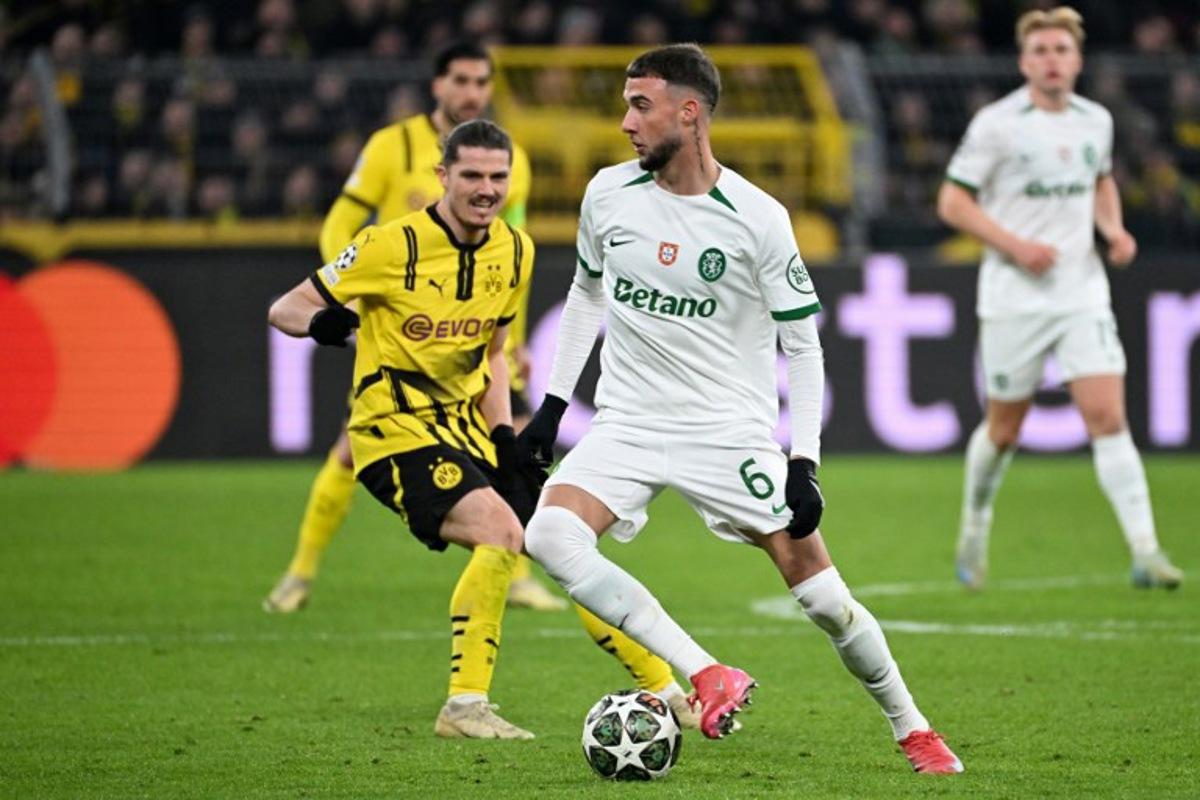 Sporting's Belgian defender #06 Zeno Debast and Dortmund's Austrian midfielder #20 Marcel Sabitzer vie for the ball during the UEFA Champions League second-leg knockout round play-off football match BVB Borussia Dortmund vs Sporting CP at the Signal Iduna stadium in Dortmund, western Germany, on February 19, 2025.  UWE KRAFT / AFP