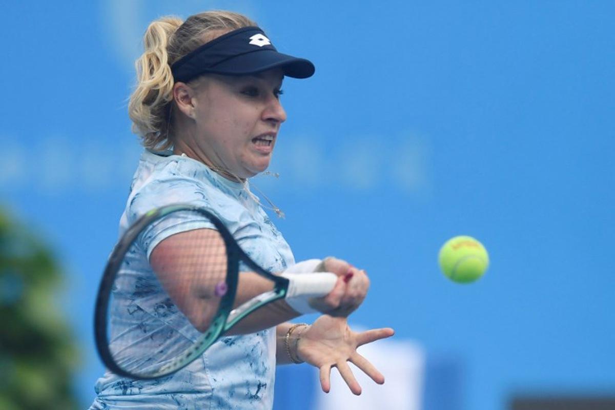 Russia's Anna Blinkova hits a return to Czech Republic's Dominika Salkova during their women's singles semi-final match at the Jiangxi Open tennis tournament in Jiujiang, central China's Jiangxi province on November 1, 2025.  STR / AFP