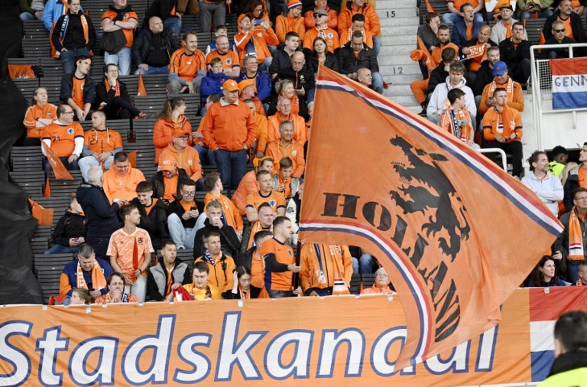Fans of the Netherlands wave a giant flag prior to the 2026 FIFA World Cup Qualifying Group G football match between Finland and the Netherlands in Helsinki on June 7, 2025.  Markku Ulander / LEHTIKUVA / AFP