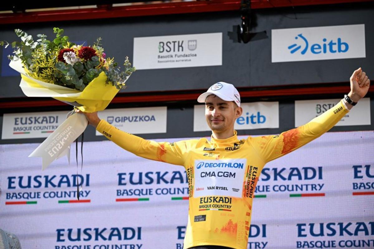 Team Decathlon CMA CGM's French rider Paul Seixas, the overall race leader and winner of the fifth stage of the Basque Country's Itzulia cycling tour, a 176.2 km race starting and finishing in Eibar, celebrates on the podium on April 10, 2026. ANDER GILLENEA / AFP