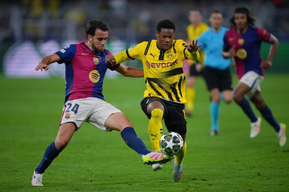 Barcelona's Spanish defender #24 Eric Garcia (L)and Dortmund's Belgian forward #16 Julien Duranville vie for the ball during the UEFA Champions League quarter-final second leg football match between BVB Borussia Dortmund and FC Barcelona in Dortmund, western Germany on April 15, 2025.  Pau BARRENA / AFP