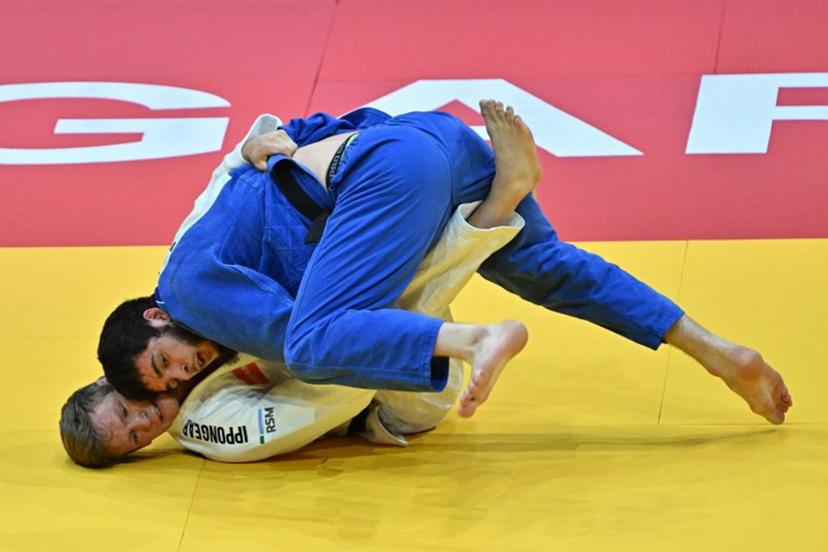 Belgium's Matthias Casse competes against United Arab Emirates' Gadzhimurad Omarov (blue) in the men's -81kg qualification round of the Judo World Championships at Papp Laszlo Arena in Budapest, Hungary, on June 16, 2025.    Attila KISBENEDEK / AFP
