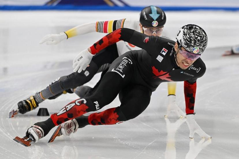 Canada's William Dandjinou (front) leads Belgium's Stijn Desmet in the men's 1500 meter final at the ISU World Short Track Championships in Beijing on March 15, 2025.  GREG BAKER / AFP