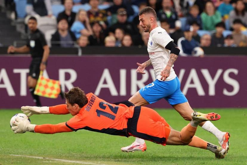 Sydney FC's goalkeeper Harrison Devenish-Meares dives to save a shot from Lion City Sailors' Maxime Lestienne during the second leg of the AFC Champions League Two semi-final at Allianz Stadium in Sydney on April 16, 2025.  DAVID GRAY / AFP