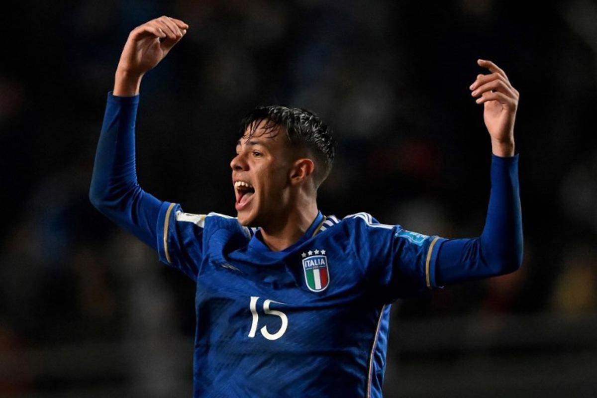 Italy's defender Alessandro Fontanarosa celebrates a goal scored by midfielder Cesare Casadei during the Argentina 2023 U-20 World Cup round of 16 football match between England and Italy at the Diego Armando Maradona stadium in La Plata, Argentina, on May 31, 2023.  LUIS ROBAYO / AFP