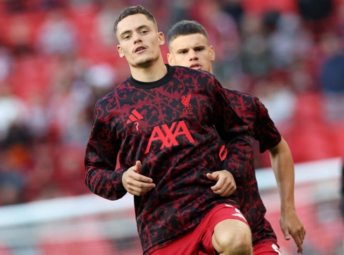 Liverpool's German midfielder #07 Florian Wirtz (L) and Liverpool's Hungarian defender #06 Milos Kerkez warm up ahead of the second of two pre season friendly football matches between Liverpool and Athletic Bilbao at Anfield in Liverpool, north west England on August 4, 2025.  Darren Staples / AFP