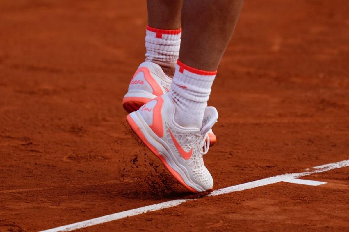 Spain's Rafael Nadal serves the ball to Italy's Flavio Cobolli during the ATP Barcelona Open "Conde de Godo" tennis tournament singles match at the Real Club de Tenis in Barcelona, on April 16, 2024.  PAU BARRENA / AFP