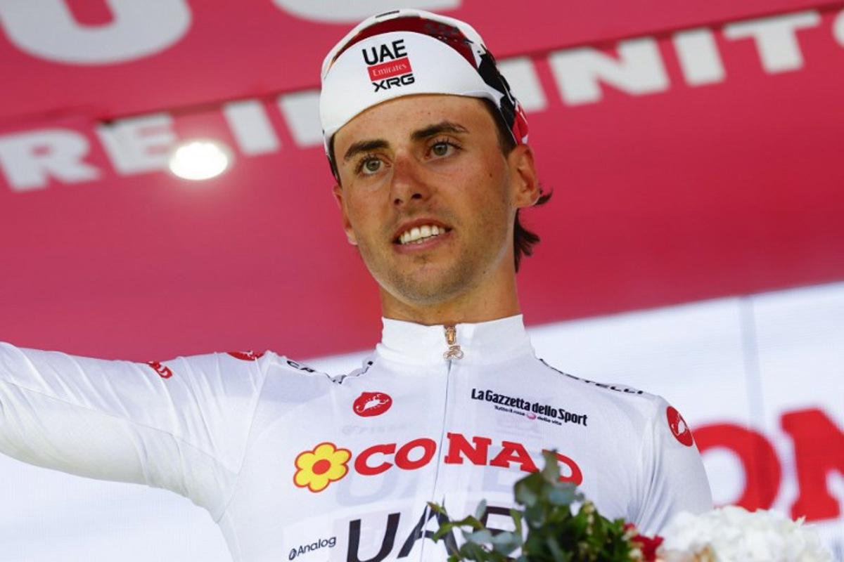 UAE Team Emirates - XRG Swiss rider Jan Christen wearing the best young rider's white jersey (Maglia Bianca) poses on the podium after the 4th stage of the Giro d'Italia 2026 - Tour of Italy cycling race between Catanzaro and Cosenza, Italy, on May 12, 2026.  Luca Bettini / AFP
