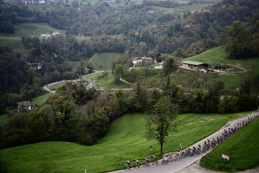 The pack of riders (peloton) cycles in the Zambla Alta ascent during the 119th edition of the Giro di Lombardia (Tour of Lombardy), a 238km cycling race from Como to Bergamo on October 11, 2025.  Marco BERTORELLO / AFP