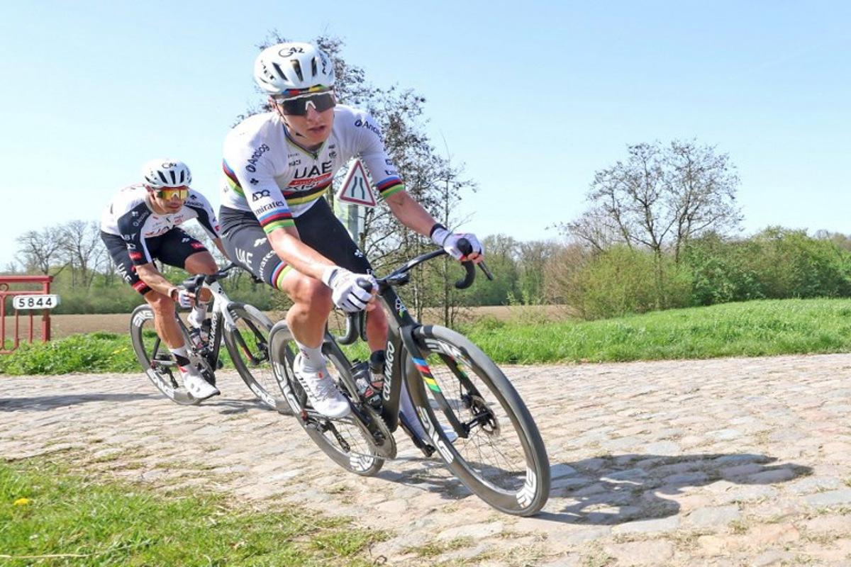 UAE Emirates-XRG's Slovenian rider Tadej Pogacar (R) rides with his team over the cobblestones of the "trench" of Brillon, northern France, on April 9, 2026, to reconnoiter the cobblestones of the 123rd Paris-Roubaix race, which will take place on April 12.  Francois LO PRESTI / AFP