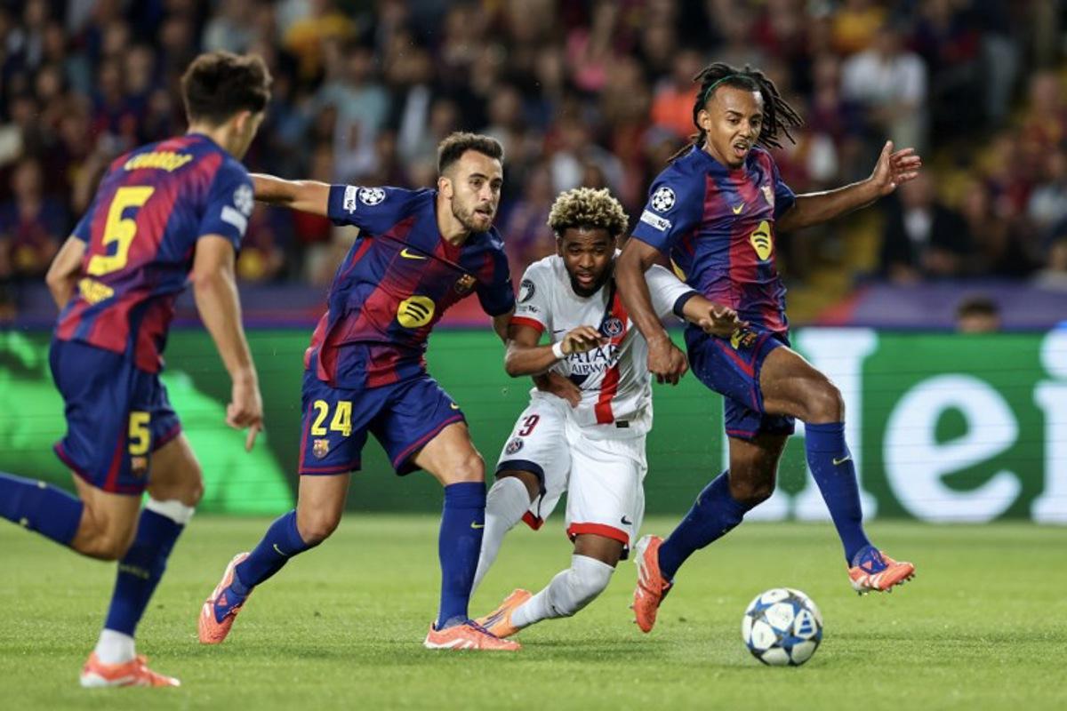 Paris Saint-Germain's French forward #49 Ibrahim Mbaye (C) vies for the ball with Barcelona's Spanish defender #24 Eric Garcia and Barcelona's French defender #23 Jules Kounde (R) during the UEFA Champions League league phase day 2 football match between FC Barcelona and Paris Saint-Germain (PSG) at the Estadi Olimpic Lluis Companys in Barcelona, on October 1, 2025.  Josep LAGO / AFP