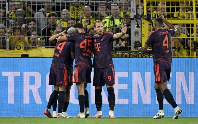 (R-L) Bayern Munich's German defender #04 Jonathan Tah, Bayern Munich's English forward #09 Harry Kane, Bayern Munich's German midfielder #45 Aleksandar Pavlovic and Bayern Munich's Colombian forward #14 Luis Diaz celebrate after their team scored the 0-1 goal during the Franz Beckenbauer Supercup football match between Borussia Dortmund and FC Bayern Munich on August 22, 2026 in Dortmund, western Germany.  INA FASSBENDER / AFP