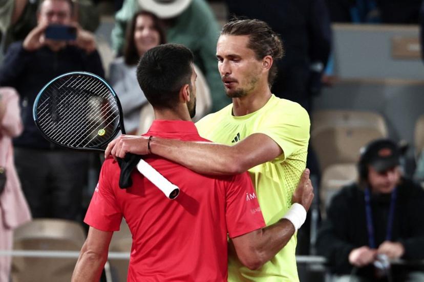 Winner Serbia's Novak Djokovic (L) cheers Germany's Alexander Zverev at the end of their men's singles quarter-final match on day 11 of the French Open tennis tournament on Court Philippe-Chatrier at the Roland-Garros Complex in Paris on June 4, 2025.  Thibaud MORITZ / AFP