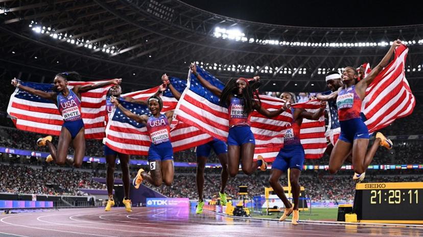 (From L) US' athlete Kayla White, US' athlete Christian Coleman, US' Sha'carri Richardson, US' Noah Lyles, US' Twanisha Terry, US' Courtney Lindsey, US' Kenneth Badnarek and US' Melissa Jefferson-Wooden celebrate winning the men's and women's 4x100m finals during the World Athletics Championships in Tokyo on September 21, 2025.  Jewel SAMAD / AFP