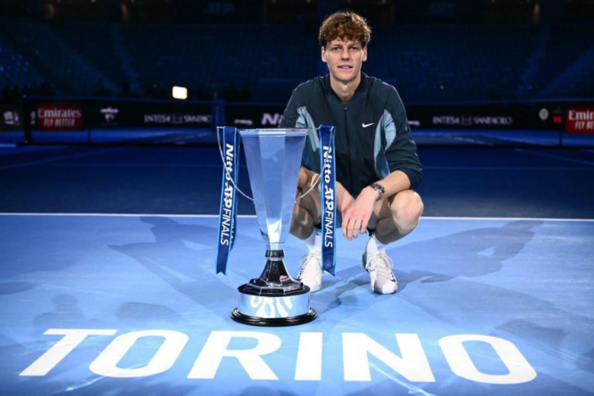 Italy's Jannik Sinner poses with the trophy after winning the final against USA's Taylor Fritz at the ATP Finals tennis tournament in Turin on November 17, 2024.  Marco BERTORELLO / AFP