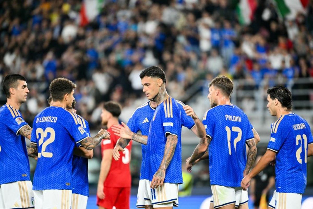 Italy's forward #11 Gianluca Scamacca celebrates after scoring a goal with his teammates  during the UEFA Nations League football match (League A day 4, Group A1) between Italy and Turkey at the Renato Dall'Ara Stadium in Bologna on October 5, 2026.  Alberto PIZZOLI / AFP
