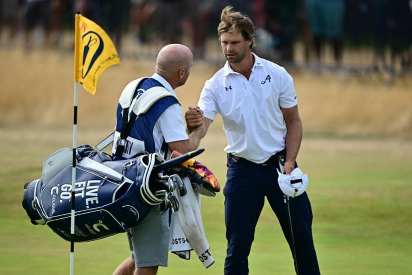 Belgium's Thomas Detry shakes hands with his caddie Lee Warne after his second round 69 on day two of the 154th Open Golf championship at Royal Birkdale Golf Club near Southport in north-west England on July 17, 2026.  Ben STANSALL / AFP