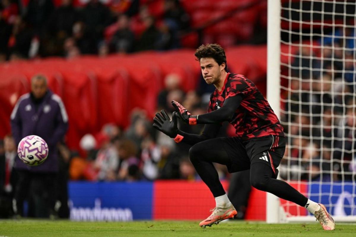 Manchester United's Belgian goalkeeper #31 Senne Lammens warms up for the English Premier League football match between Manchester United and Brighton and Hove Albion at Old Trafford in Manchester, north west England, on October 25, 2025.  Oli SCARFF / AFP