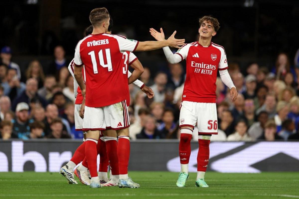 Arsenal's English midfielder #56 Max Dowman (R) celebrates scoring the team's third goal during the League Cup third Round football match between Ipswich Town and Arsenal at Portman Road in Ipswich, eastern England on September 15, 2026.  Adrian Dennis / AFP