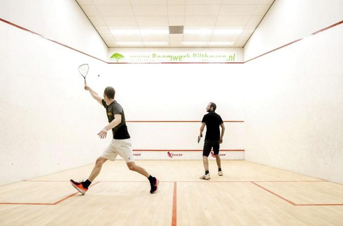Visitors hit their ball at Squash Utrecht in Utrecht, on April 10, 2021.  The accommodation is the very first indoor sports location that is allowed to reopen after the lockdown ; a negative Covid-19 test certificate is required to enter.  Remko de Waal / ANP / AFP Netherlands OUT

