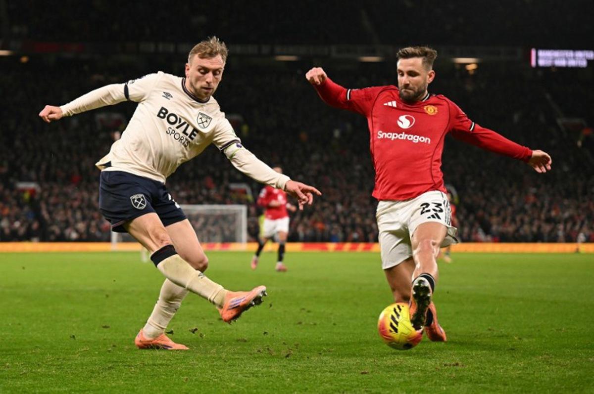 Manchester United's English defender #23 Luke Shaw blocks a cross from West Ham United's English striker #20 Jarrod Bowen during the English Premier League football match between Manchester United and West Ham United at Old Trafford in Manchester, north west England, on December 4, 2025.  Oli SCARFF / AFP
