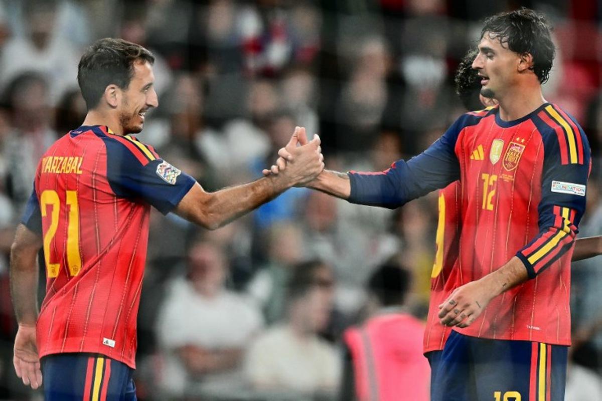 Spain's striker #21 Mikel Oyarzabal (L) celebrates scoring the team's third goal with Spain's defender #12 Marc Pubill (R) during the UEFA Nations League, League A - Group 3, football match between England and the Spain at Wembley Stadium in London on September 26, 2026.   Ben STANSALL / AFP