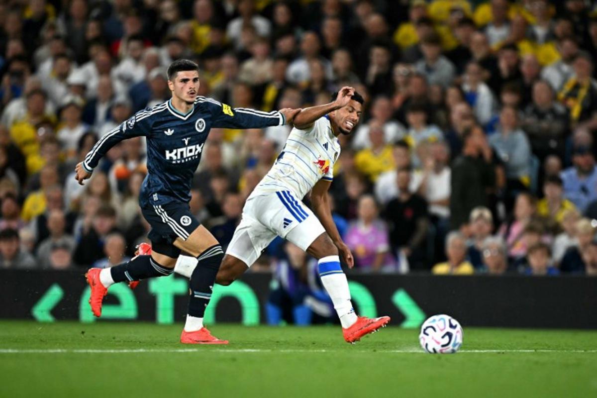 Newcastle United's Belgian striker #20 Matias Fernandez-Pardo battles for the ball with Leeds United's English defender #24 James Justin during the English Premier League football match between Leeds United and Newcastle United at Elland Road in Leeds, northern England on September 14, 2026.  Paul ELLIS / AFP