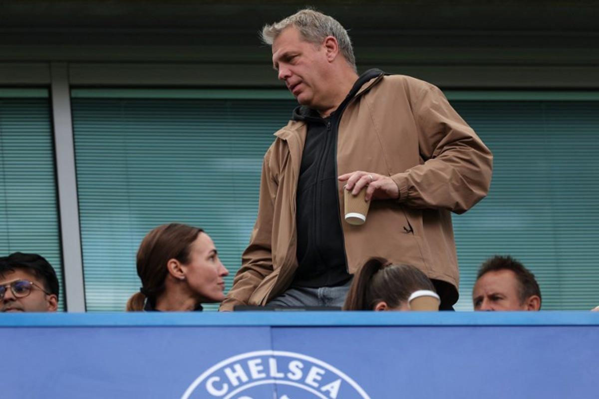 Chelsea's US owner Todd Boehly (C) takes his seat before the start of the English Premier League football match between Chelsea and Brighton and Hove Albion at Stamford Bridge in London on August 30, 2026.  Adrian Dennis / AFP