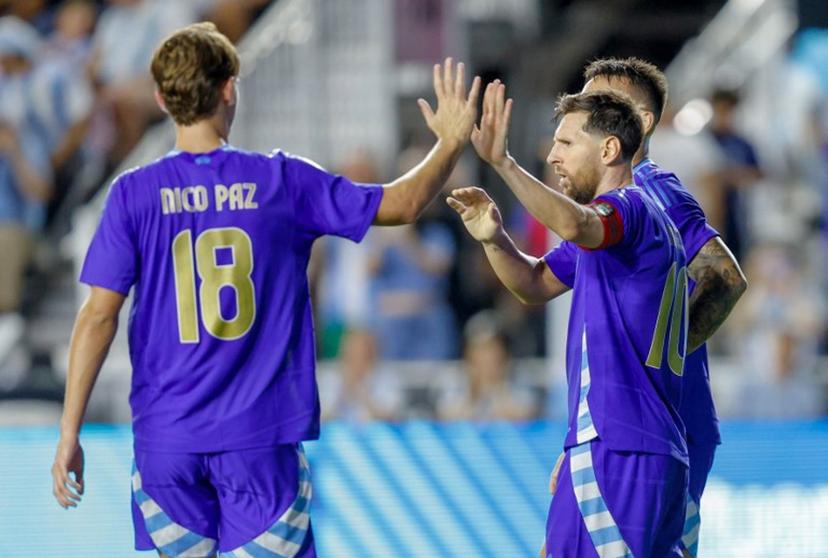 Argentina's forward #10 Lionel Messi and Argentina's midfielder #18 Nico Paz celebrate a goal during the international friendly football match between Argentina and Puerto Rico at Chase Stadium in Fort Lauderdale, Florida, on October 14, 2025.  Chris Arjoon / AFP