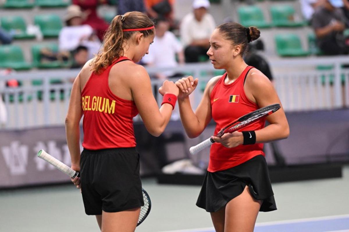 Belgium's Hanne Vandewinkel (L) and Sofia Costoulas (R) speak during their women's doubles match against China's Guo Hanyu and Jiang Xinyu at the Billie Jean King Cup tennis play-offs at the Guangzhou Nansha International Tennis Center in Guangzhou, in south China's Guangdong province on November 17, 2024.   STR / AFP