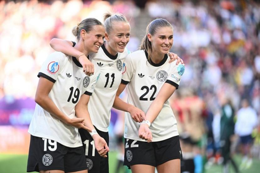 Germany's forward #11 Lea Schueller (C) celebrates with Germany's midfielder #19 Klara Buehl (L) and Germany's midfielder #22 Jule Brand (R) after scoring her team's second goal during the UEFA Women's Euro 2025 Group C football match between Germany and Denmark at the at the St Jakob-Park Stadium, in Basel on July 8, 2025.  SEBASTIEN BOZON / AFP