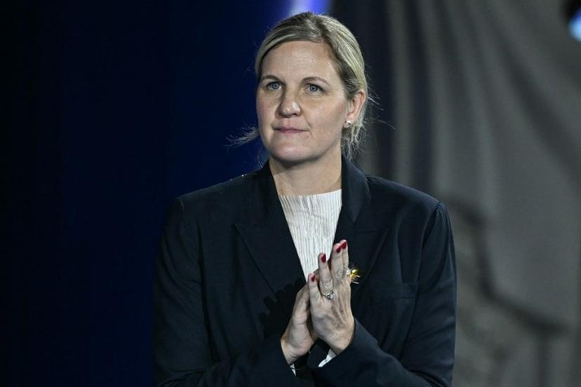 The President of the International Olympic Committee Kirsty Coventry reacts on the podium of the women's 100m backstroke swimming event during the 2025 World Aquatics Championships in Singapore on July 29, 2025.  Oli SCARFF / AFP