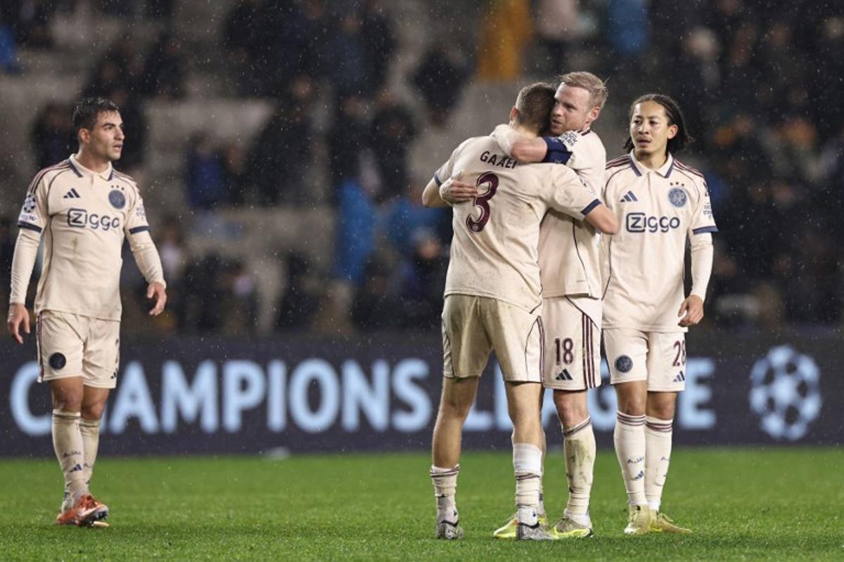 Ajax's players celebrate after the UEFA Champions League league phase football match between Qarabag and Ajax at the Tofiq Bahramov Republican Stadium in Baku on December 10, 2025.  Giorgi ARJEVANIDZE / AFP