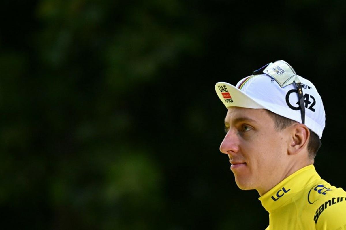 UAE Team Emirates - XRG team's Slovenian rider Tadej Pogacar celebrates on the podium with the overall leader's yellow jersey after the 21st and final stage of the 112th edition of the Tour de France cycling race, 132.3 km between Mantes-la-Ville and Paris Champs-Élysees, on July 27, 2025.  Loic VENANCE / AFP