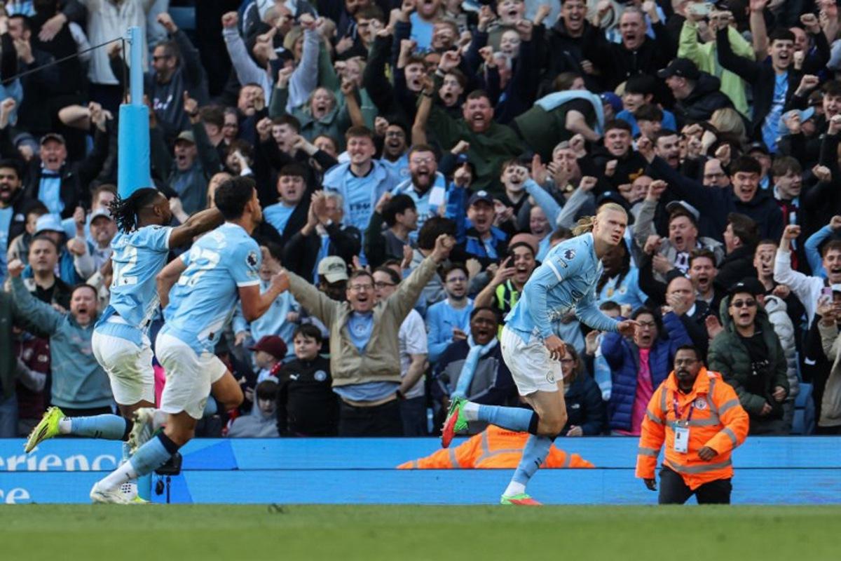 Manchester City's Norwegian striker #09 Erling Haaland (R) celebrates after scoring his team's second goal during the English Premier League football match between Manchester City and Arsenal at the Etihad Stadium in Manchester, north west England, on April 19, 2026.  Darren Staples / AFP