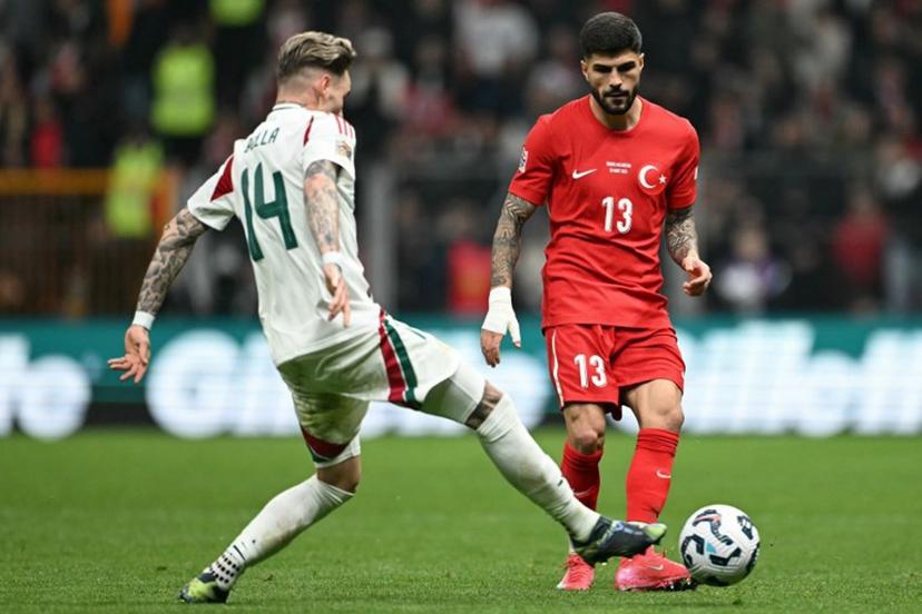 Hungary's defender #14 Bendeguz Bolla fights for the ball with Turkey's defender #13 Eren Elmali during the UEFA Nations League playoff first-leg football match between Turkey and Hungary at the Rams Park Ali Samiyen Sport Complex Stadium in Istanbul on March 20, 2025.  OZAN KOSE / AFP