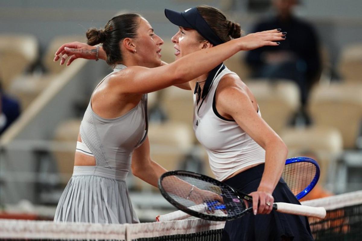 Ukraine's Marta Kostyuk (L) and Ukraine's Elina Svitolina (R) embrace at the end of their women's quarter final singles match on day 10 of the French Open tennis tournament on Court Philippe-Chatrier at the Roland-Garros Complex in Paris on June 2, 2026.  Dimitar DILKOFF / AFP