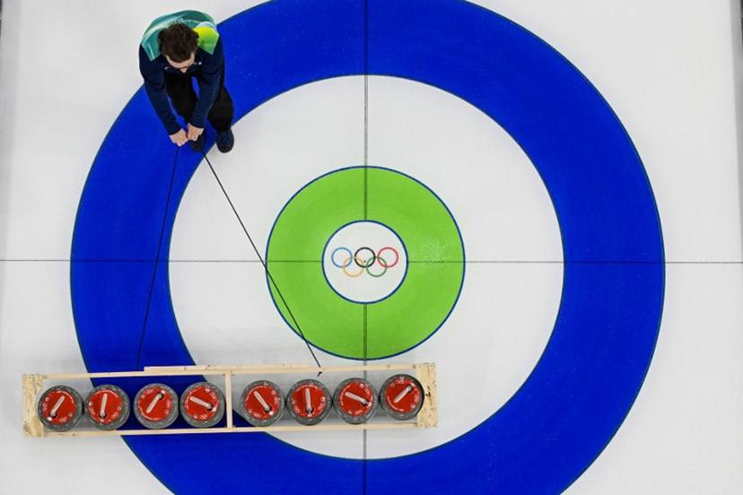 A staff member prepare the stones ahead of the first round of curling at the Olympic stadium in Cortina, northern Italy, prior to the Milano Cortina 2026 Olympic Games, on February 4, 2026. The curling competition commences two days ahead of the official opening of the Milano-Cortina2026 Olympic Winter Games. Odd ANDERSEN / AFP