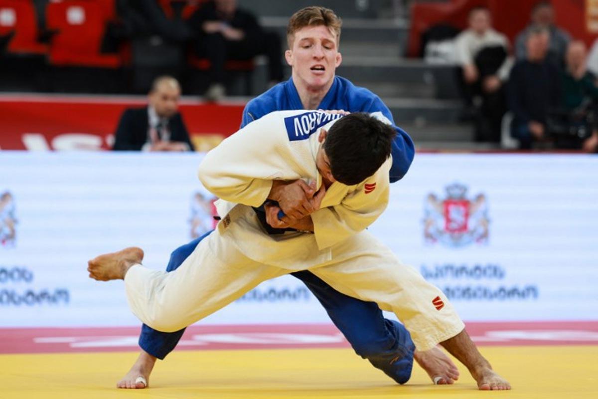 Uzbekistan's Samariddin Kuchkarov (white) competes against Belgium's Jorre Verstraeten in the men's under 60 kg bronze medal bout at the Tbilisi Grand Slam judo tournament in Tbilisi on March 20, 2026.  Giorgi ARJEVANIDZE / AFP