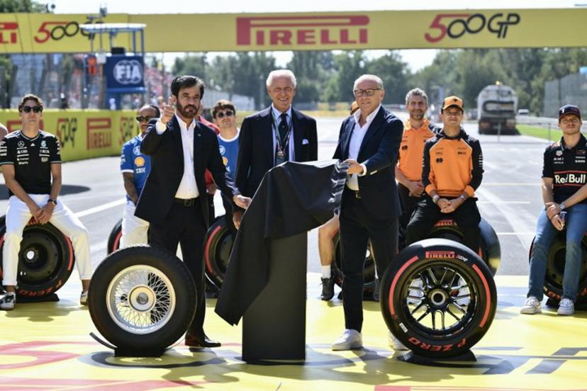 FIA president Mohammed Ben Sulayem (L), Pirelli CEO Marco Tronchetti Provera (C) and F1 CEO Stefano Domenicali (R) celebrate the 500th Grand Prix for Pirelli, as they attend the drivers' parade prior to the Italian Formula One Grand Prix at the Autodromo Nazionale Monza circuit, in Monza, northern Italy, on September 7, 2025.  Marco BERTORELLO / AFP