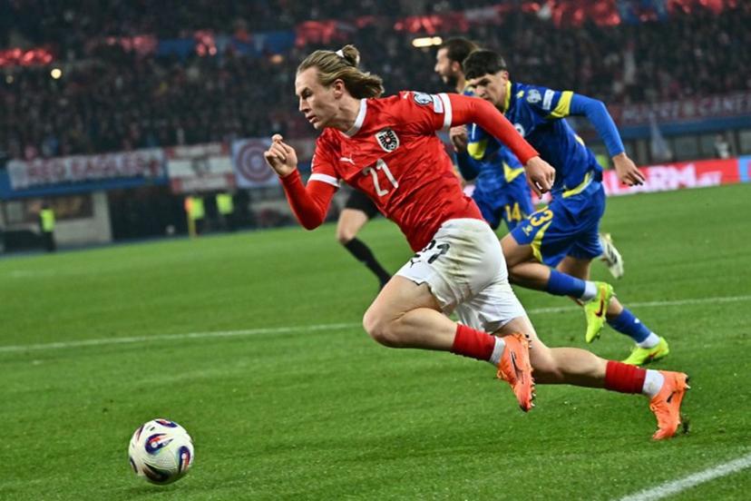 Austria's midfielder #21 Patrick Wimmer and Bosnia-Herzegovina's defender #23 Arjan Malic vie for the ball during the FIFA World Cup 2026 European qualification Group H football match between Austria and Bosnia and Herzegovina, in Vienna on November 18, 2025.  Joe Klamar / AFP