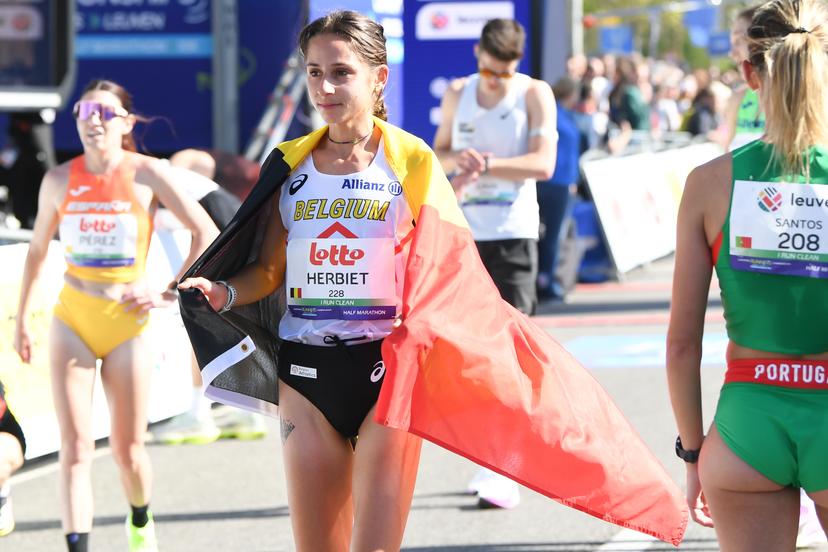 Belgian Chloe Herbiet celebrates after winning the half marathon race at European Running Championships, in Leuven, Saturday 12 April 2025. BELGA PHOTO JILL DELSAUX