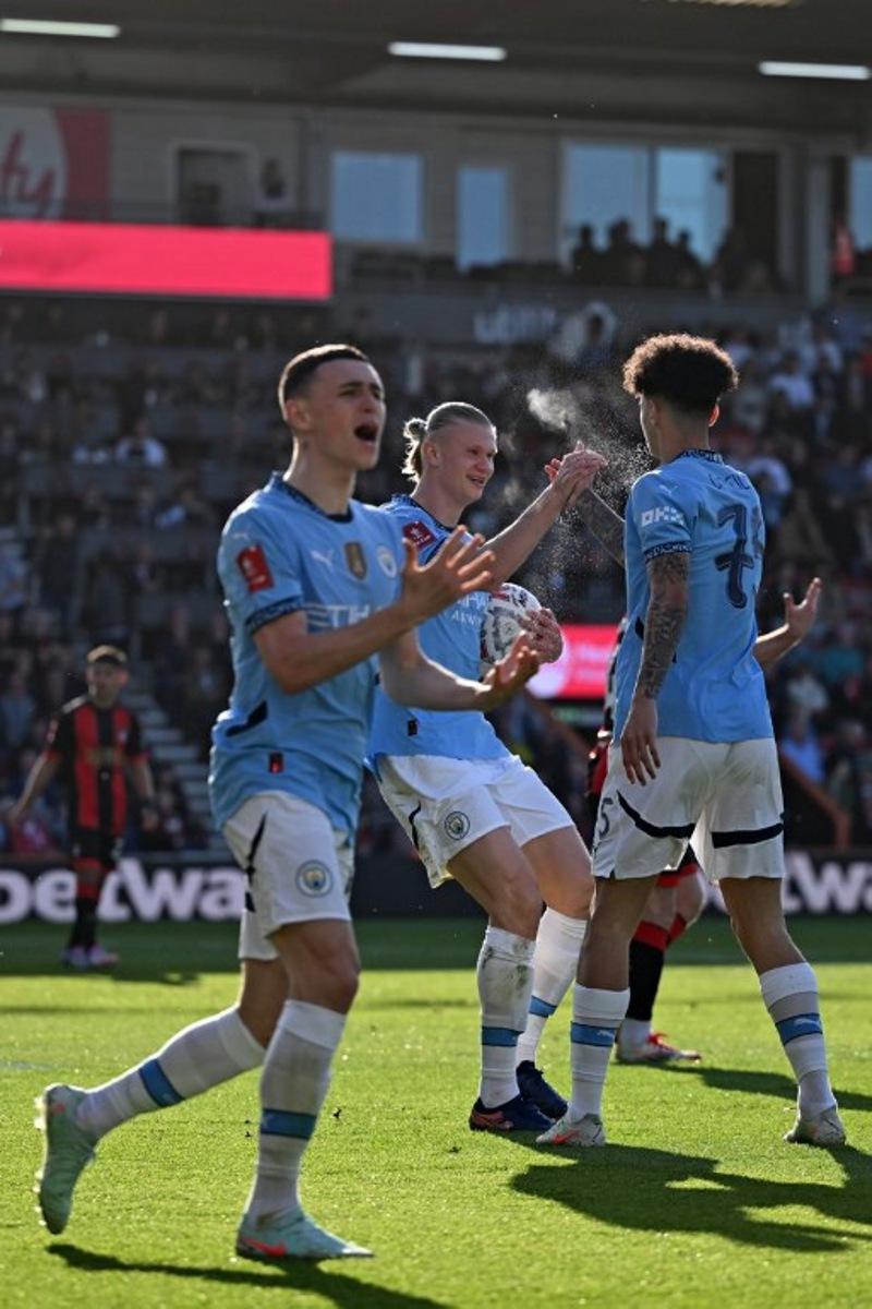 Manchester City's Norwegian striker #09 Erling Haaland (C) celebrates with Manchester City's English midfielder #75 Nico O'Reilly (R) after the two combine for their first goal during the English FA Cup quarter-final football match between Bournemouth and Manchester City at the Vitality Stadium in Bournemouth, on the south coast of England on March 30, 2025.  JUSTIN TALLIS / AFP