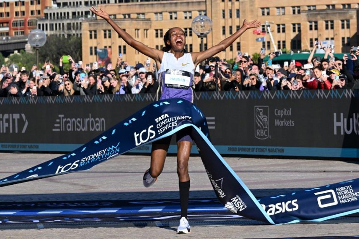 Netherlands's Sifan Hassan crosses the finish line first in the 2025 Sydney Marathon, crossing the iconic Harbour Bridge on August 31, 2025.  Saeed KHAN / AFP