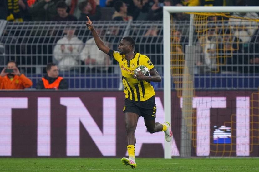 Dortmund's Guinean forward #09 Serhou Guirassy celebrates scoring the opening goal from the penalty spot during the UEFA Champions League quarter-final second leg football match between BVB Borussia Dortmund and FC Barcelona in Dortmund, western Germany on April 15, 2025.  Pau BARRENA / AFP