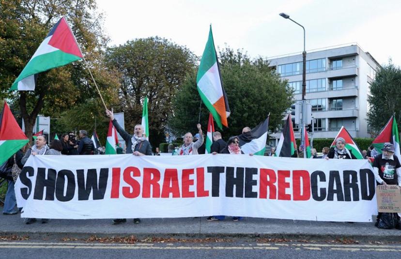 People hold placards calling on Ireland's football team not to play their next fixture against Israel, during a 'Stop The Game' protest outside Aviva Stadium in Dublin on October 1, 2026, ahead of the team's Nations League match against Austria.  Ireland coach Heimir Hallgrimsson said on September 30 they will play their second Nations League match against Israel on October 4 after the first fixture was thrown into doubt by player concerns over the Gaza war. Paul Faith / AFP