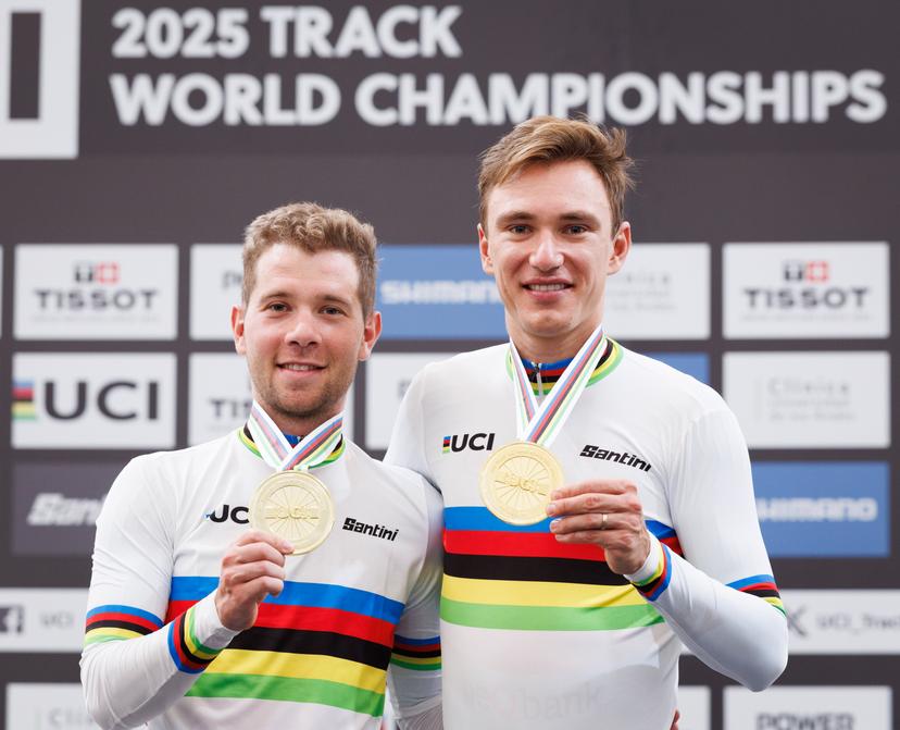 Belgian Fabio Van Den Bossche and Belgian Lindsay De Vylder celebrate celebrate on the podium with their gold medals and wearing the world champion jersey, on the podium of the podium ceremony of the men's Madison race at the 2025 UCI Track World Championships cycling, in Santiago, Chile, Sunday 26 October 2025. The Track World Championships take place from 22 to 26 October at the Velodromo de Penalolen in Santiago, Chile. BELGA PHOTO BENOIT DOPPAGNE