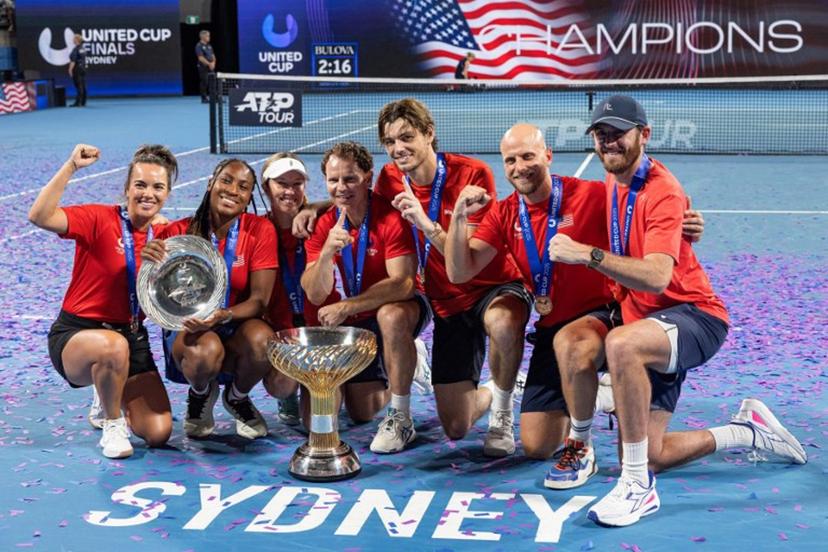 Players of Team USA celebrate with the trophy after beating team Poland in the finals of the United Cup tennis tournament on Ken Rosewall Arena in Sydney on January 5, 2025.  Steve CHRISTO / AFP