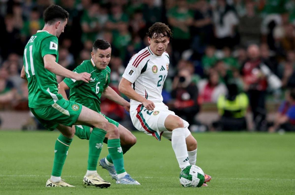 Republic of Ireland's midfielder #11 Finn Azaz battles for the ball with Hungary's midfielder #21 Alex Toth during the 2026 World Cup Group F qualifier football match between Republic of Ireland and Hungary, at Aviva Stadium, in Dublin, on September 6, 2025.   Paul Faith / AFP