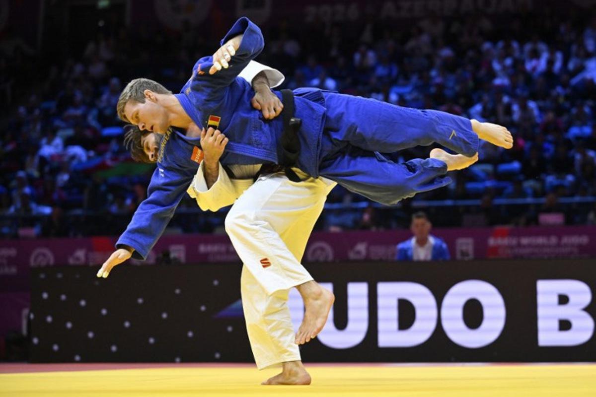 Azerbaijan's Zelim Tckaev (white) competes against Belgium's Matthias Casse in the men's under 81 kg quarter-final at the World Judo Championships in Baku on October 7, 2026.  Alexander NEMENOV / AFP